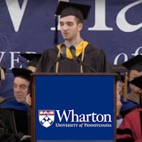 a man in a cap and gown speaks at a graduation ceremony